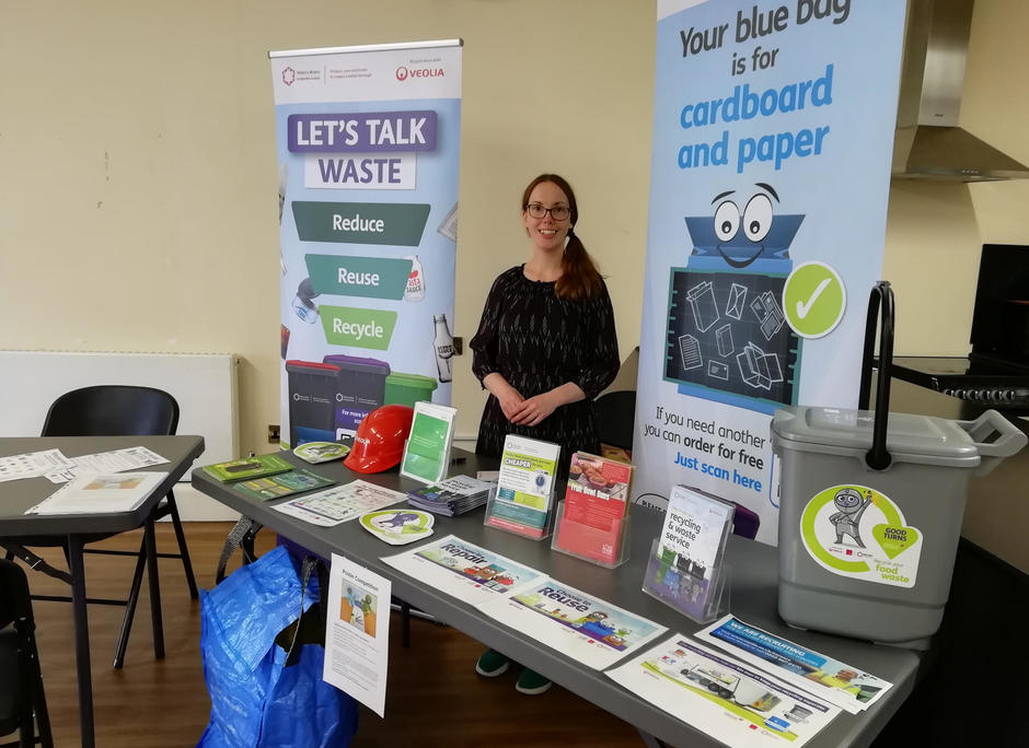 Photo of someone at an information stand with banners