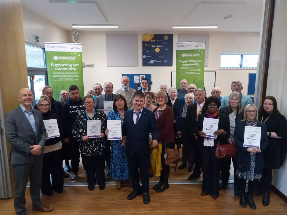 Image of about 40 people holding certificates