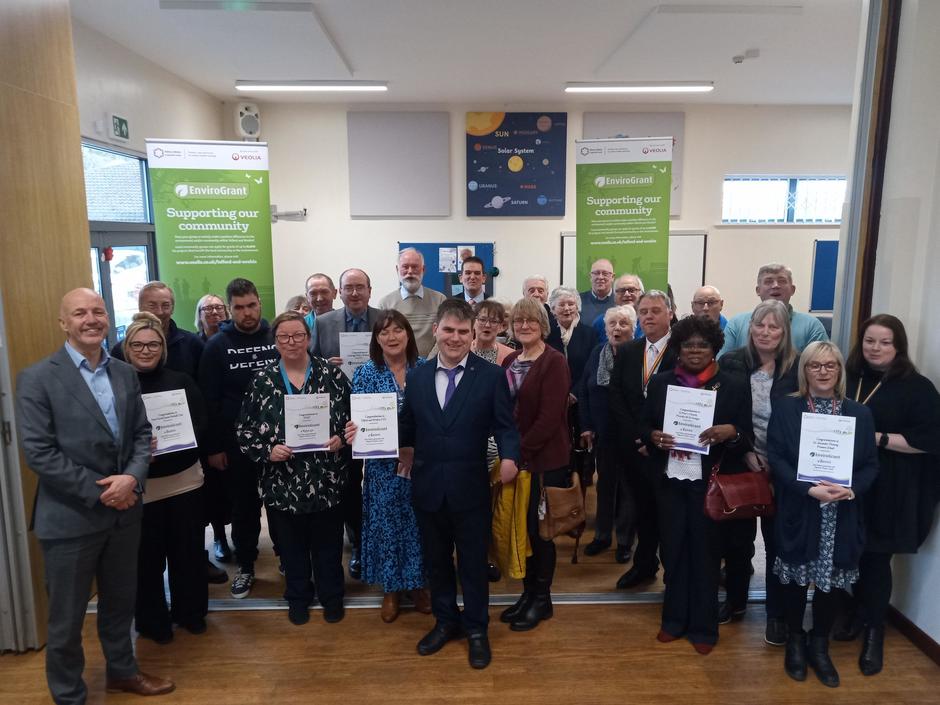 Image of about 40 people holding certificates